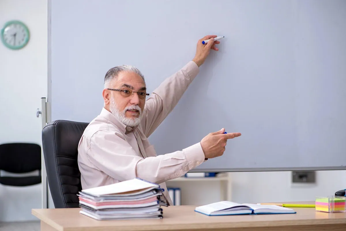 Is the Social Security COLA Formula Flawed? 3 A senior man points at a whiteboard.