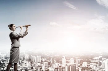 a businesswoman looks out with a spyglass.