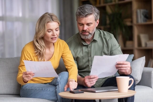 middle aged couple reviewing finances together