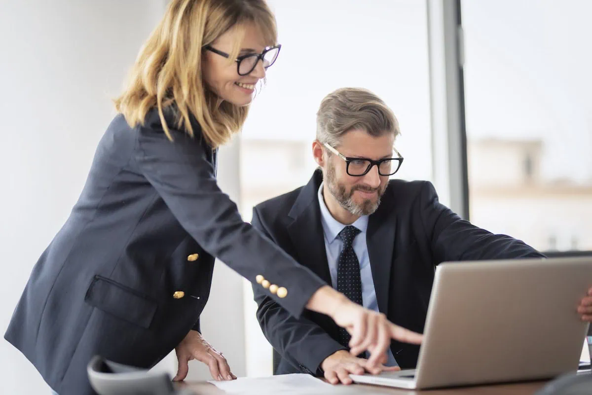 middle-aged couple looking at laptop together smiling