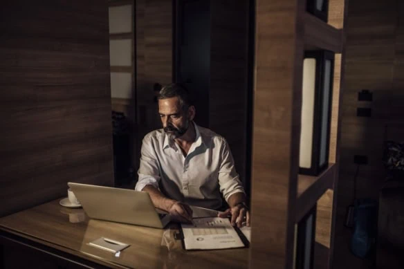 middle-aged man working job late at night