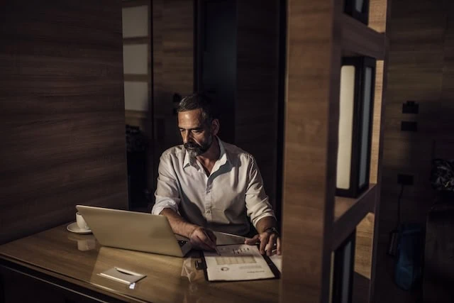 middle-aged man working job late at night