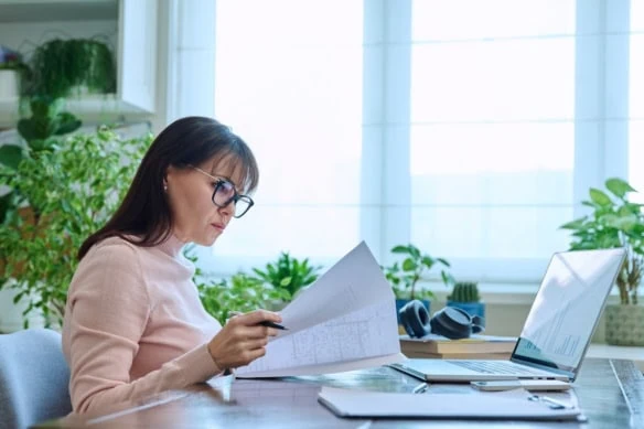 Mature serious business woman working at computer, workplace boss entrepreneur