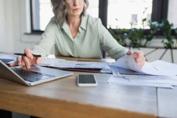 middle-aged woman working from home on laptop