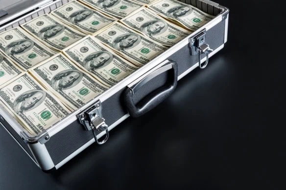 The frugal filter: 10 ways to strip way debt and design a minimalist money mindset 1 a briefcase full of hundred dollar bills.