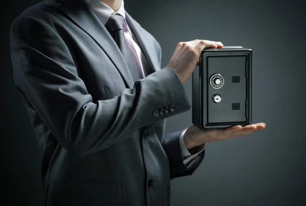 a businessman protects his savings in the safe.
