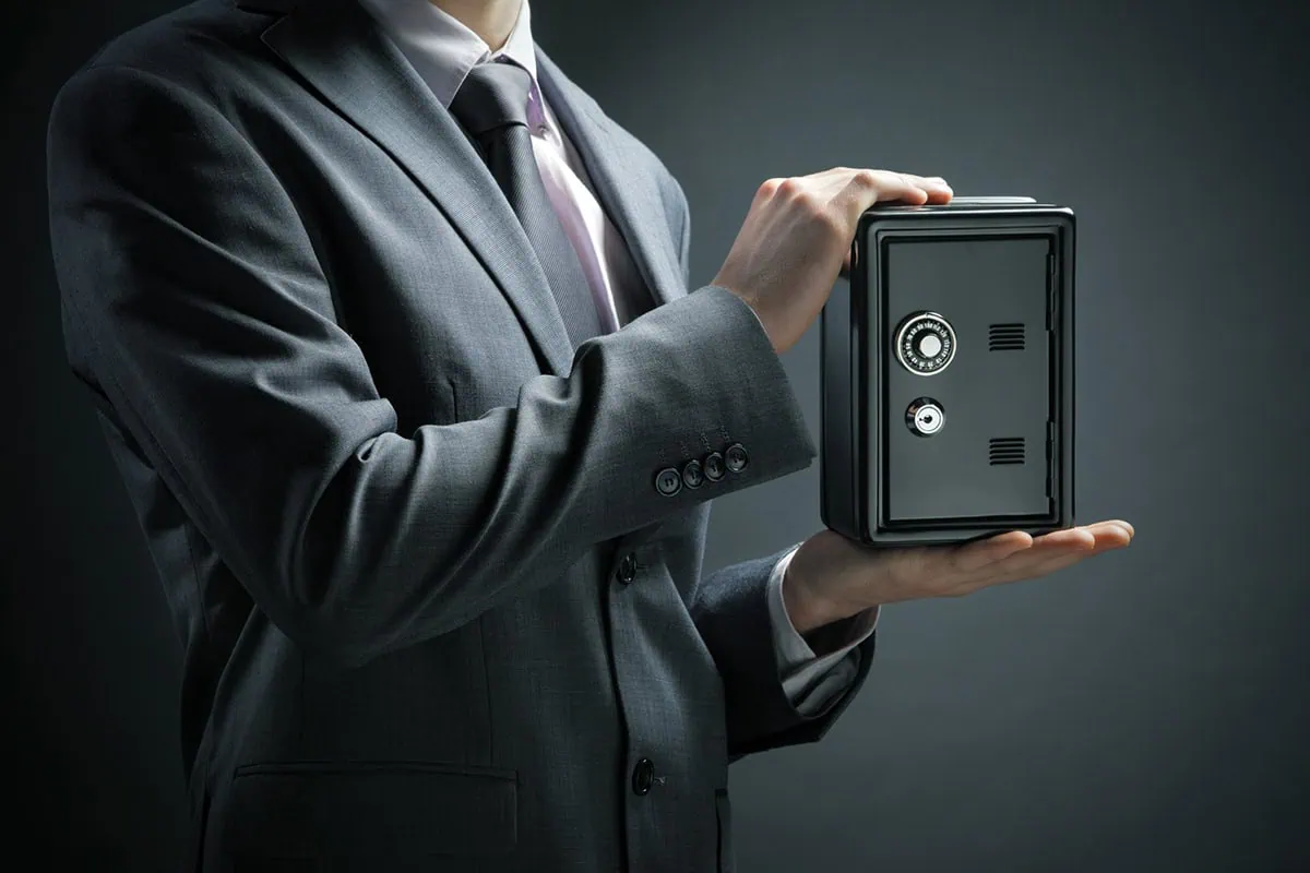 a businessman protects his savings in the safe.