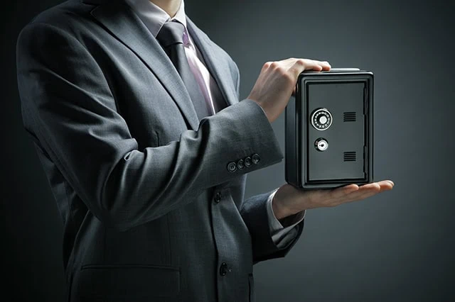 a businessman protects his savings in the safe.