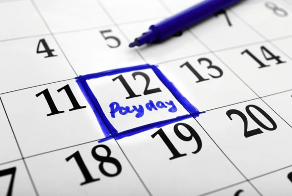 a calendar with a day circled in blue that says payday.