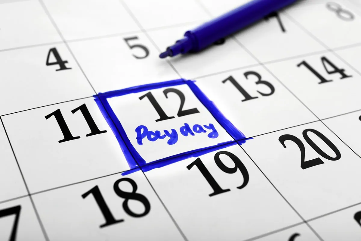 a calendar with a day circled in blue that says payday.