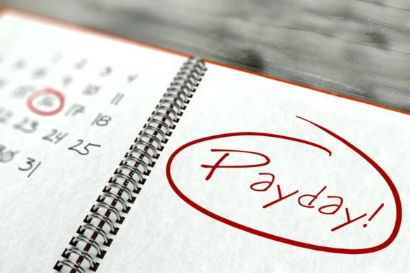 10 monthly dividend payers that yield up to 15.4% 1 a date circled on a notebook with the word payday written on the other side.