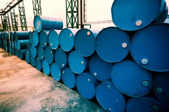 blue oil drums stacked on their sides.