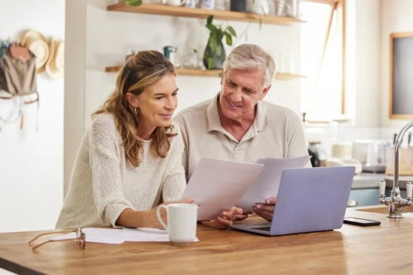 Retirement, finance and couple with budget on laptop satisfied