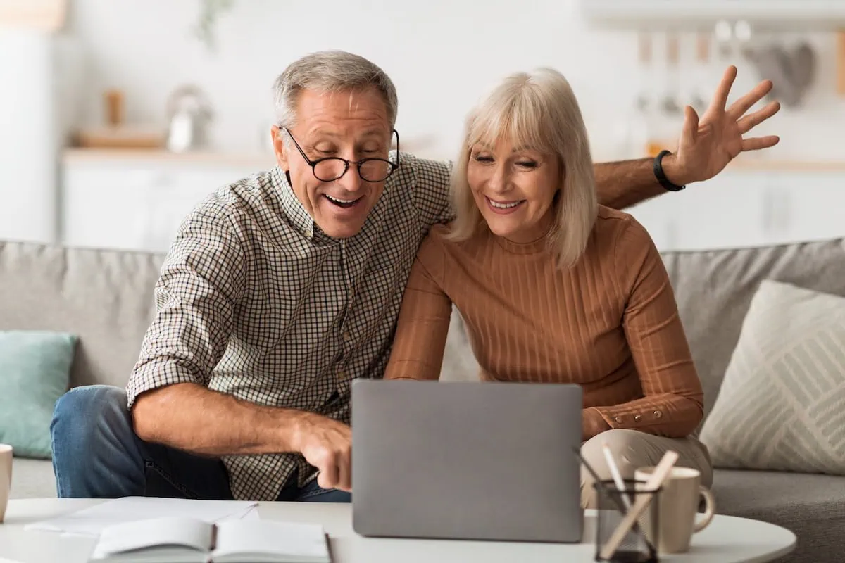 Have an IRA? Don't Make These 10 Costly Mistakes 3 senior spouses smiling at computer happy