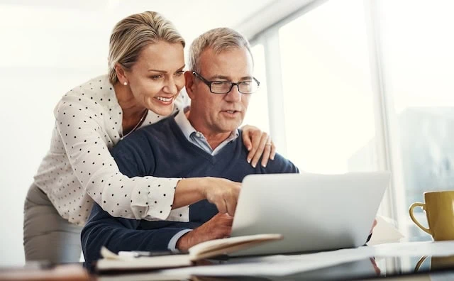 older couple looking at computer making decisions together