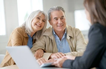 Senior couple meeting financial adviser for investment