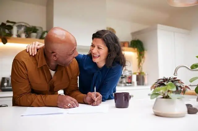 older couple reviewing finances laughing medium