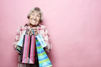 older woman smiling with shopping bags