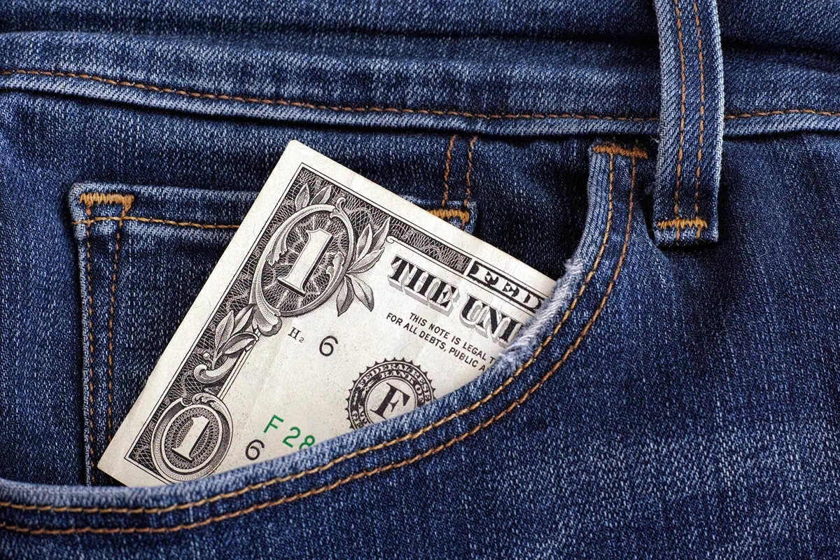 a one dollar bill in a pair of jeans.