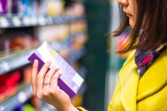 a person looks at an item in the grocery store