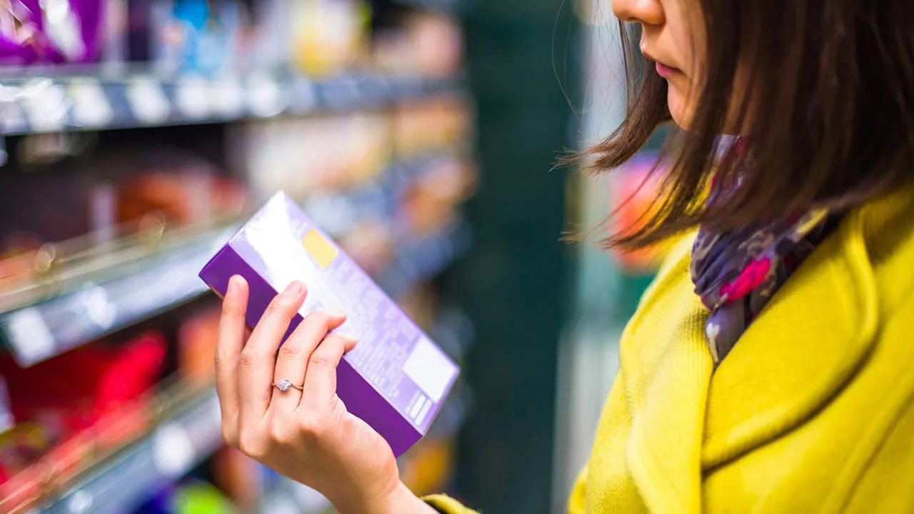 a person looks at an item in the grocery store