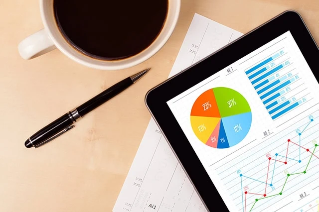 charts are shown on a laptop.