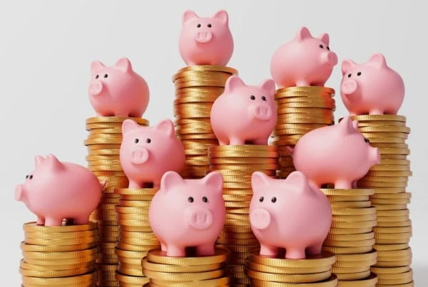 piggy banks on top of coins