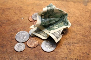 a dollar and change lying on a table.