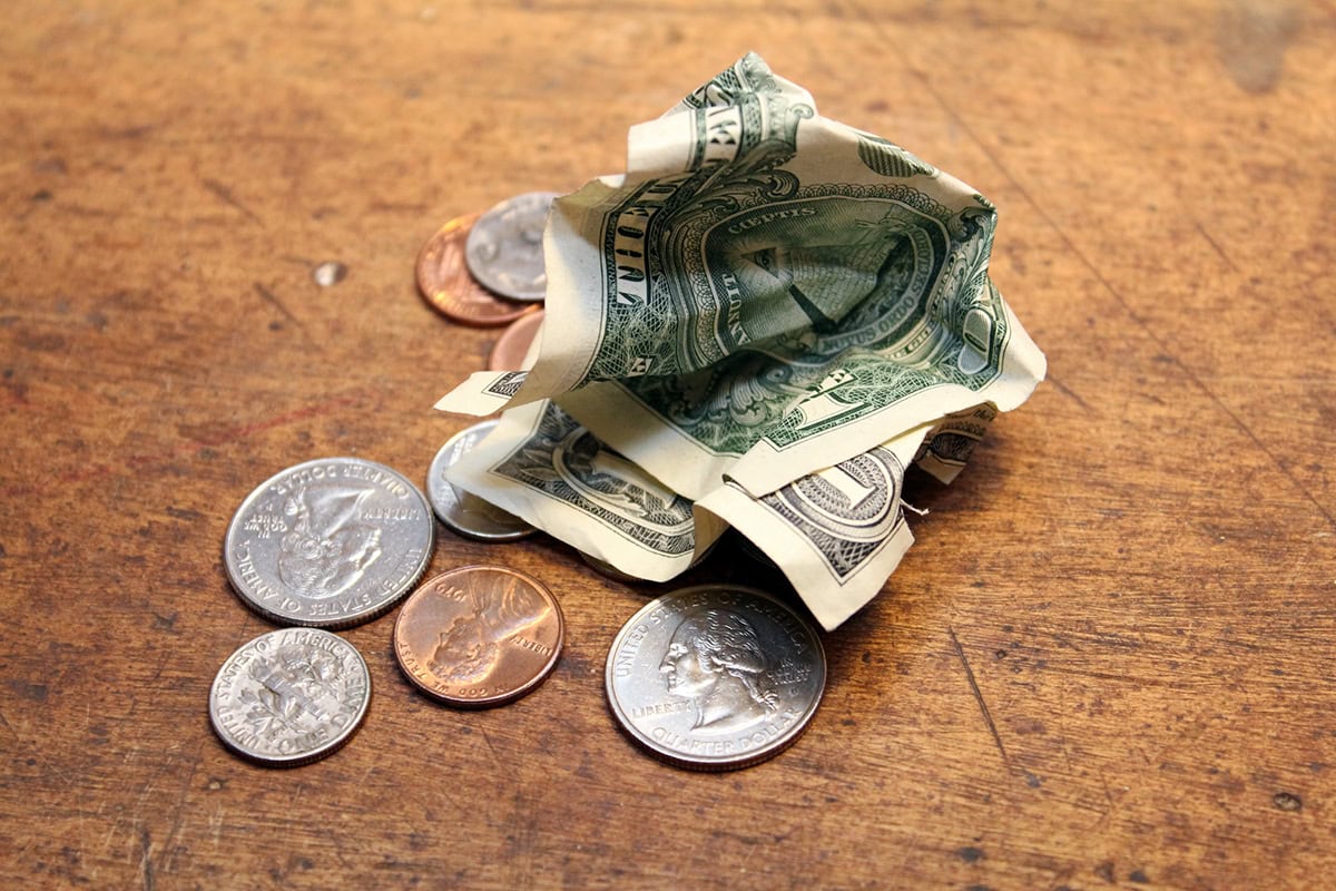 a dollar and change lying on a table.