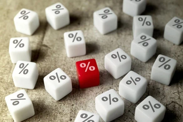 several white dice with percent signs on them and one red die with a percent sign that stands out.