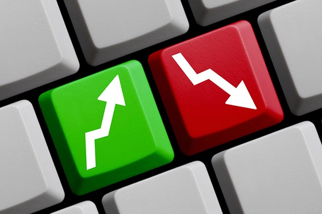 Should You Outsource Your Financial Advice to ChatGPT? 2 concept of two keys on a keyboard, one with a green up arrow, one with a red down arrow.