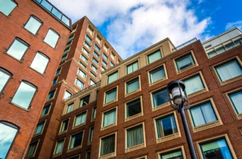 a brick apartment building in the sunlight.
