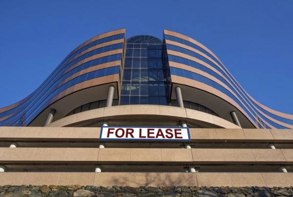 a large office building has a sign that says for lease.