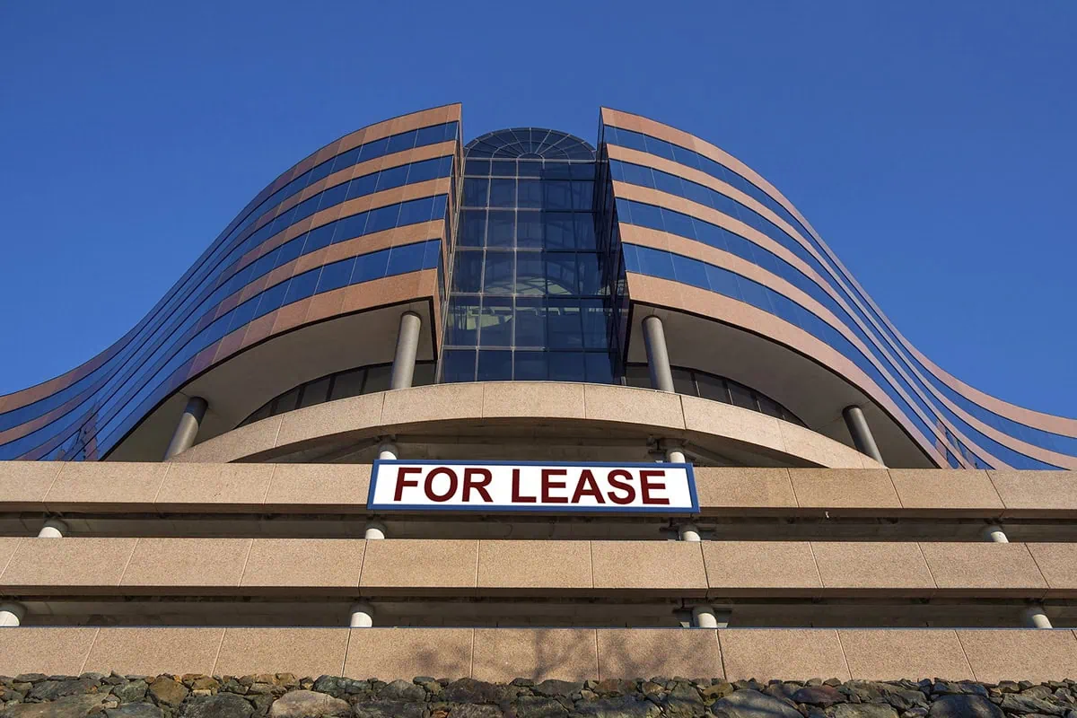 ๐ The Top Tools for Landlords Managing Their Own Rental Properties 7 a large office building has a sign that says for lease.