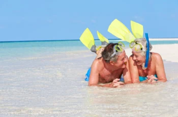 a happy older couple in snorkeling gear.