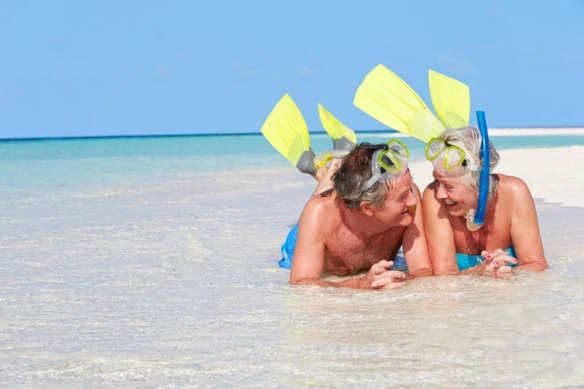 a happy older couple in snorkeling gear.