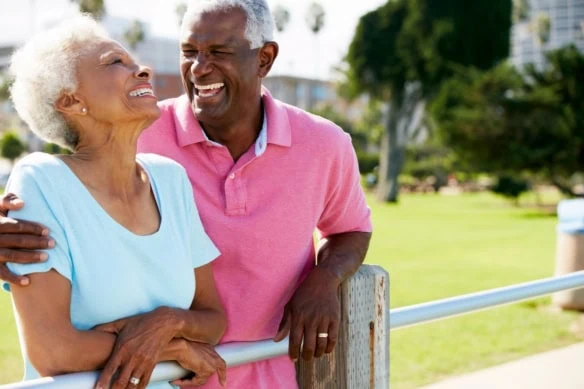 Senior Couple Walking In Park Together