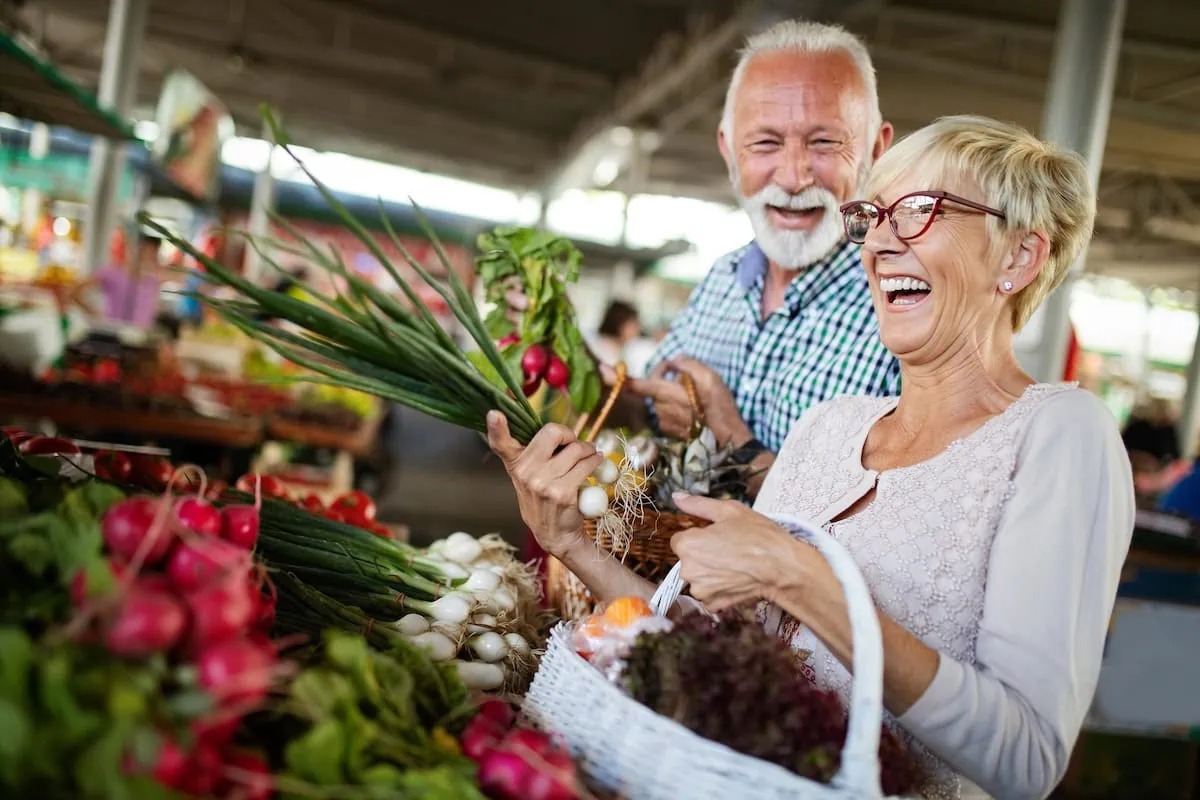 Walmart, Sam's Club, or Costco: Which Grocery Chain Is Best for Seniors? 2 senior fresh groceries shopping basket vegetables