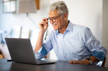Close up businessman with glasses looking at laptop computer