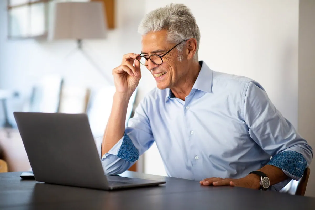 Should You Stop Working Cold Turkey or Ease Out of It? Designing Your Ultimate Retirement Exit Strategy 2 Close up businessman with glasses looking at laptop computer