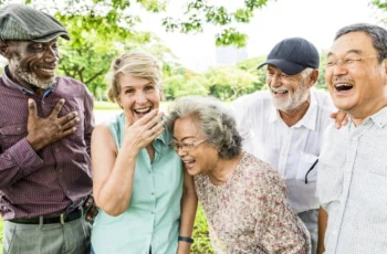 seniors laughing in a park happy elderly