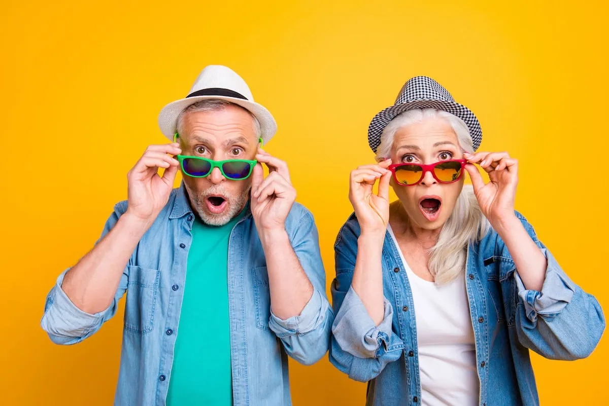 Senior Status Has Its Privileges: Dozens of Ways to Pay Less This Week 2 seniors surprised and lowering sunglasses 1200