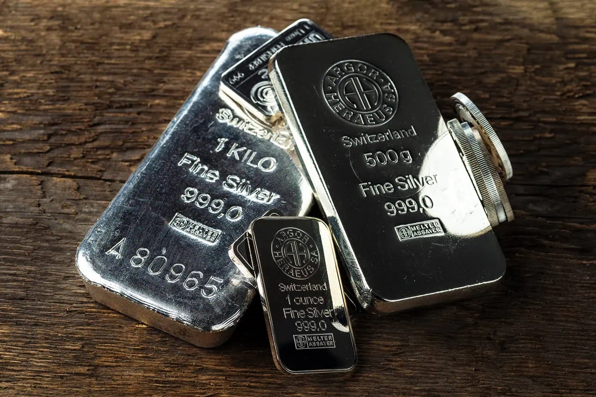 Take Home the Silver ... With These 5 Silver ETFs 2 Silver bars against a dark background.