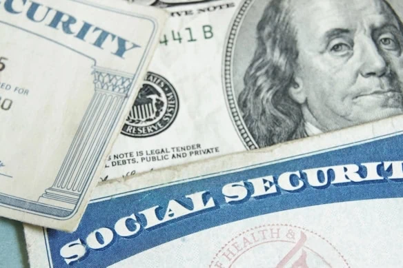 social security cards laid over money