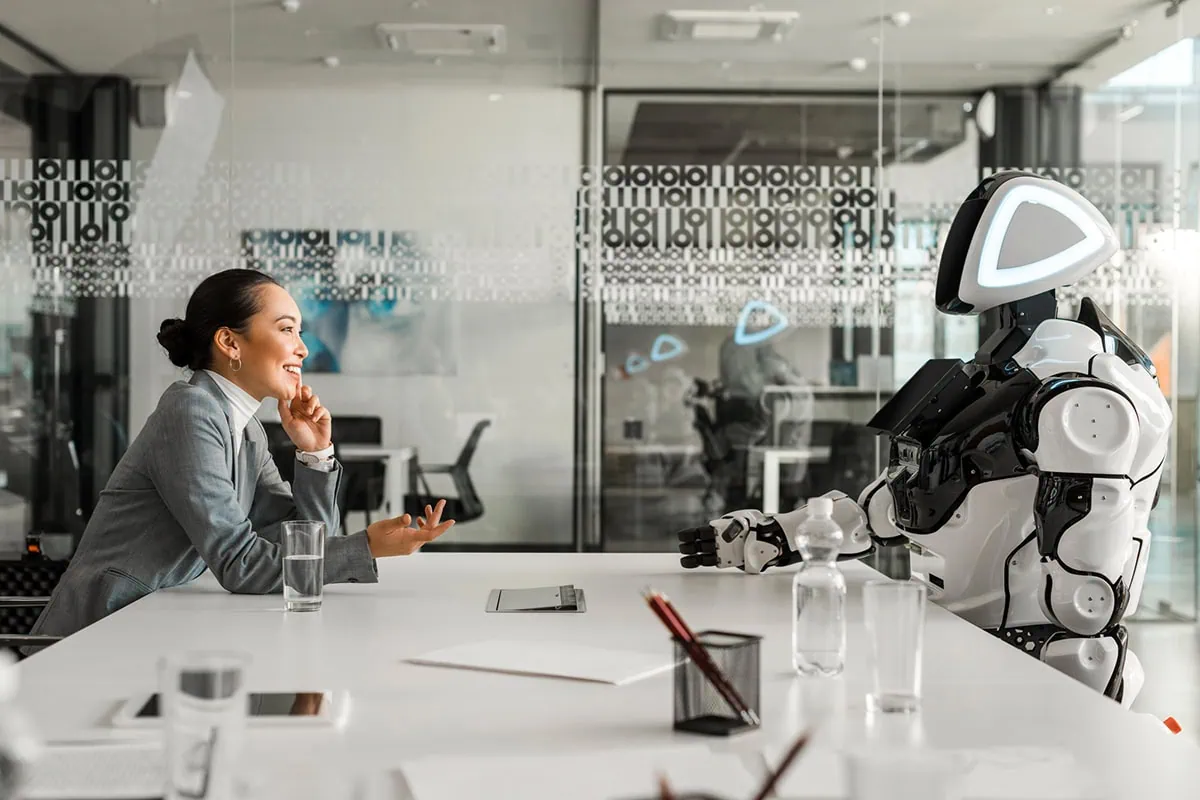 Reach for the Stars: 7 ETFs Riding the Space Economy Boom 4 Concept art of a robot talking to a person in a futuristic lab break room.