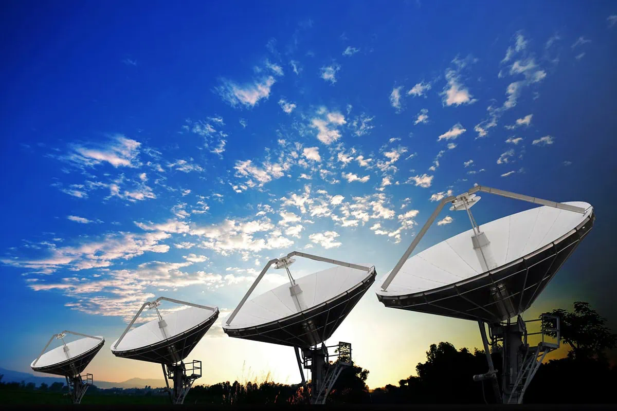 Reach for the Stars: 7 ETFs Riding the Space Economy Boom 6 Several satellite dishes against a blue sky.