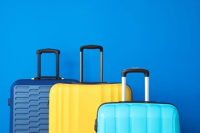 splurging on suitcase luggage blue