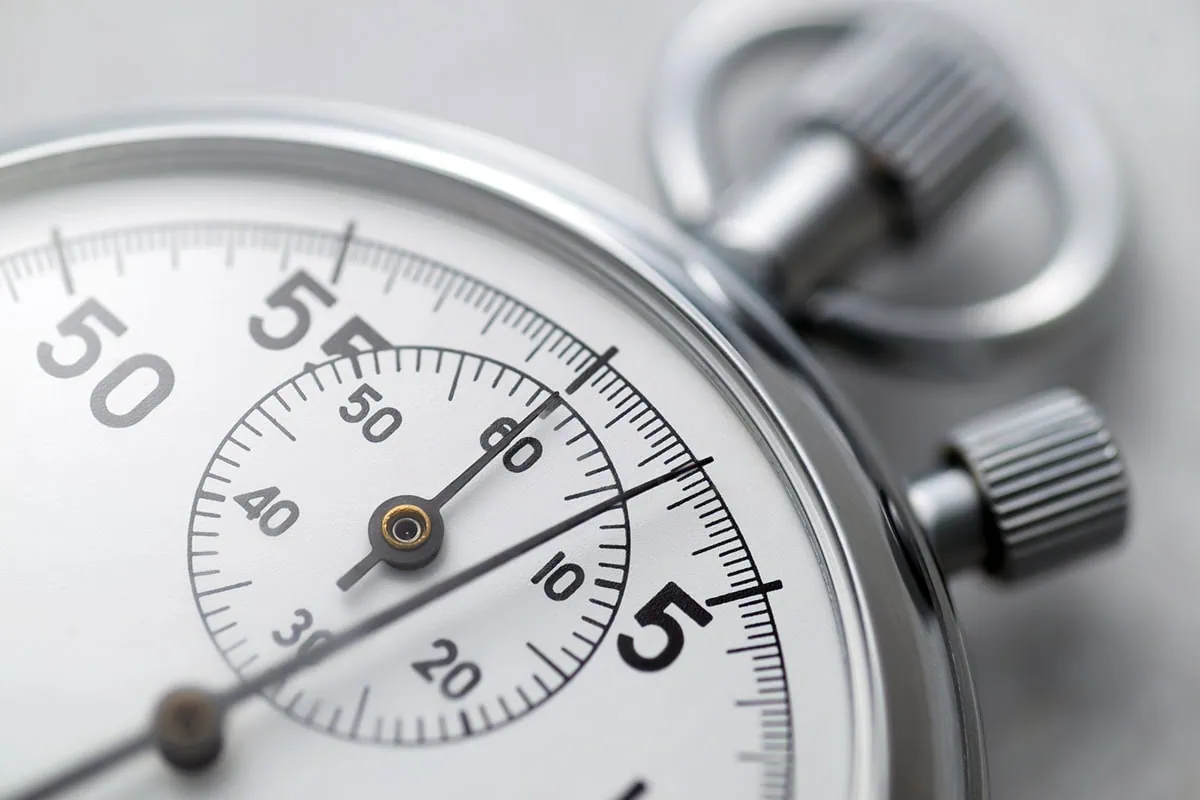a closeup of a stopwatch against a white background.