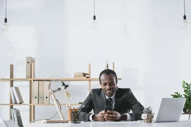 man on phone near laptop