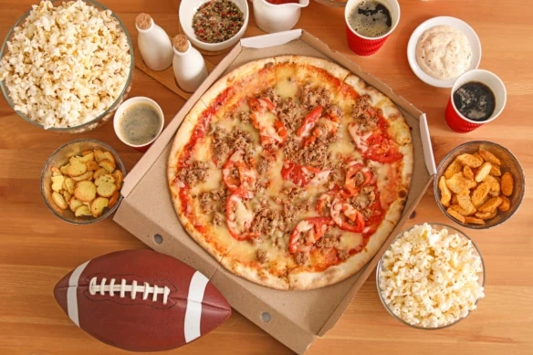 Table with tasty snacks prepared for watching football on TV